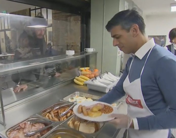 cringe:-british-pm-serving-meals-at-homeless-shelter-asks-homeless-man,-“do-you-work-in-business?”-“no,-i’m-homeless”