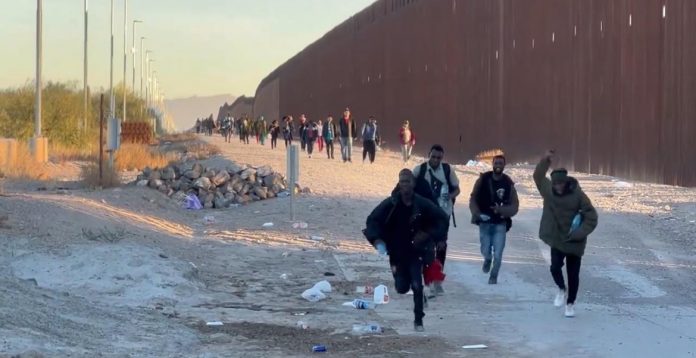 developing:-border-wall-breach-and-mass-incursion-taking-place-in-lukeville,-arizona–-endless-line-of-african-illegals-charge-over-border-(video)