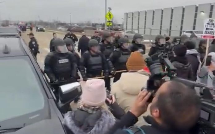 protestors-line-the-street-to-greet-joe-biden-in-detroit;-police-in-riot-gear-arrive-(video)