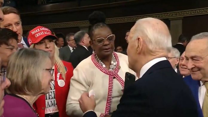 wow!-marjorie-taylor-greene-hands-joe-biden-a-pin-that-reads-“laken-riley”-as-he-enters-sotu–-tells-him-to-“say-her-name!”-(video)