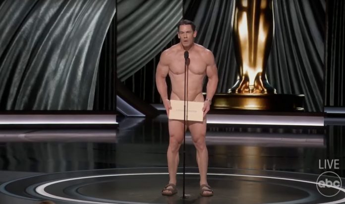 new-low-in-hollywood:-john-cena-introduces-best-costume-design-naked-with-a-big-placard-covering-his-cajones-at-the-woke-oscars