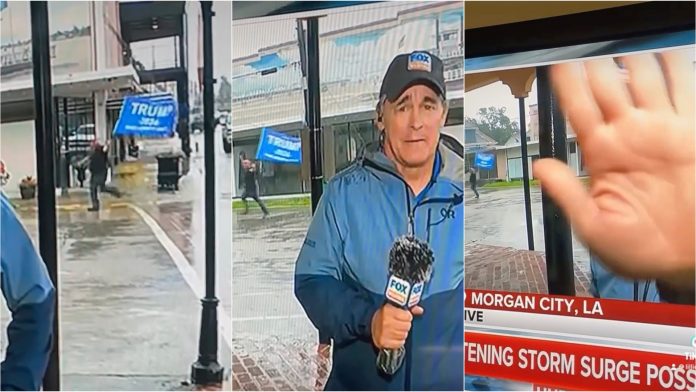 triggered-weatherman-covers-camera-as-man-with-massive-trump-flag-runs-in-background-during-hurricane-broadcast